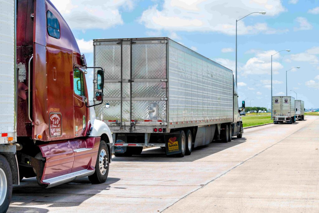 Commercial trucks lined up along a Texas highway shoulder