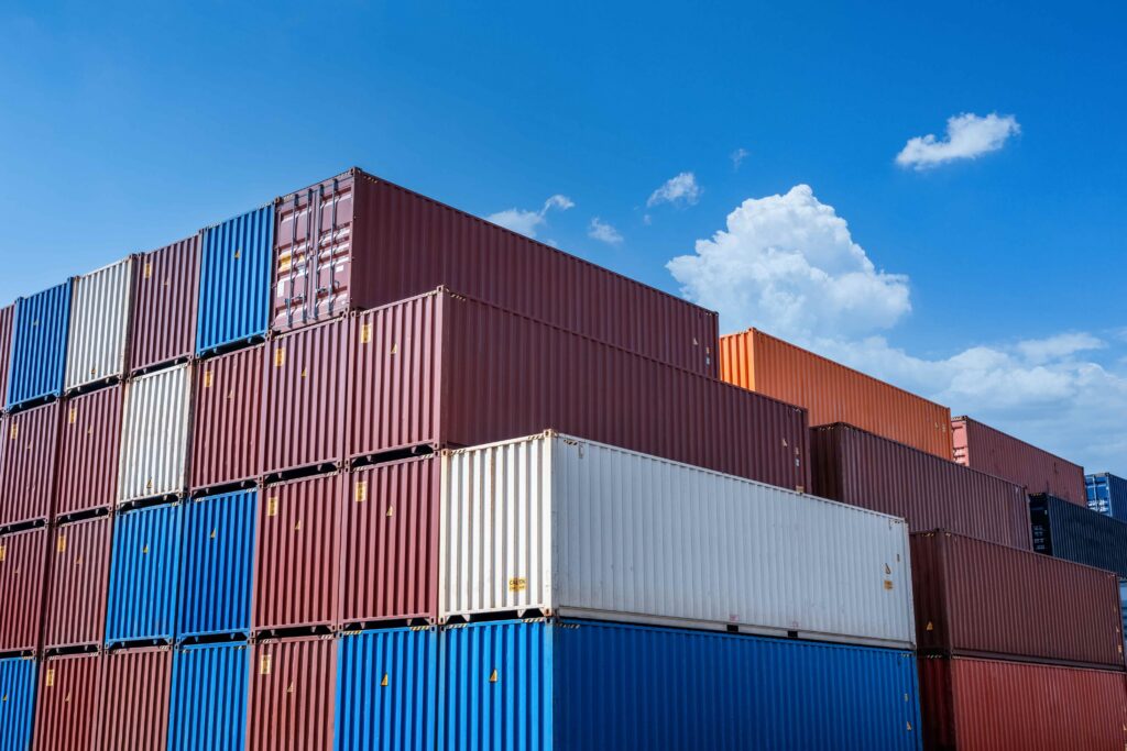 Stacked shipping containers at a freight terminal awaiting transport