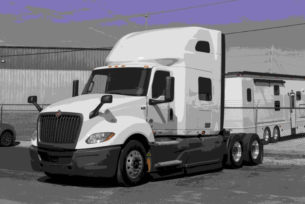 White semi-truck tractor parked in a commercial lot