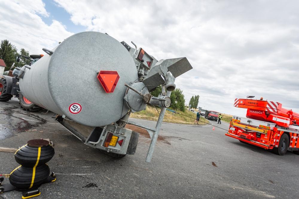 Rolled over hazmat tanker truck accident with emergency response crews on scene
